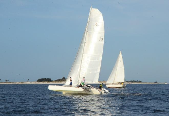 Mike Patterson's Corsair 31R 'Bellafonte' lifts a hull leaving Pensacola pass on the way to Cuba in the 2015 Andrews Institute Pensacola a la Habana Race. This has proven to be a wet ride, wetter than expected, for the little tri. Bob Kriegel's Pearson 424 'Acadia' in the background © Talbot Wilson